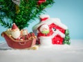 Happy Santa Claus with gifts box on the snow sled going to house. near house have Snowman and Christmas Tree. Santa Claus Royalty Free Stock Photo