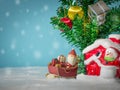 Happy Santa Claus with gifts box on the snow sled going to house. near house have Snowman and Christmas Tree. Santa Claus Royalty Free Stock Photo