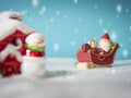 Happy Santa Claus with gifts box on the snow sled going to snow house. near snow house have Snowman and Christmas Tree. Royalty Free Stock Photo