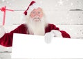 Happy santa claus holding blank placard and gift box Royalty Free Stock Photo