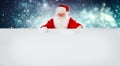 Happy Santa Claus holding Christmas blank advertisement banner background with copy space for your holiday text Royalty Free Stock Photo