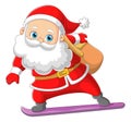 The happy Santa claus is holding the gift bag and sliding on the ice skating board Royalty Free Stock Photo