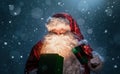 Happy Santa Claus opening christmas gift box