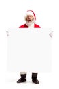 Happy Santa Claus pointing on blank advertisement banner background with copy space. Smiling Santa Claus pointing in Royalty Free Stock Photo