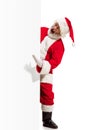 Happy Santa Claus pointing on blank advertisement banner background with copy space. Smiling Santa Claus pointing in Royalty Free Stock Photo