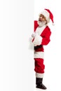 Happy Santa Claus pointing on blank advertisement banner background with copy space. Smiling Santa Claus pointing in Royalty Free Stock Photo