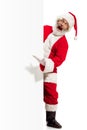 Happy Santa Claus pointing on blank advertisement banner background with copy space. Smiling Santa Claus pointing in Royalty Free Stock Photo