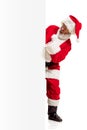 Happy Santa Claus pointing on blank advertisement banner background with copy space. Smiling Santa Claus pointing in Royalty Free Stock Photo