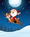 Happy Santa claus riding a reindeer in the night background Royalty Free Stock Photo