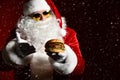 Happy Santa Claus in stylish sunglasses offer tasty burger sandwich hamburger in hand. New year