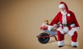 A happy Santa Claus with a wheelbarrow full of Christmas presents on a plain background with copy space