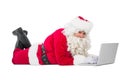 Happy santa lying and using laptop