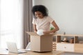 Happy satisfied black girl customer open parcel box at home