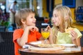 Happy or satisfied boy width girl eating pizza and Royalty Free Stock Photo