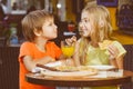 Happy or satisfied boy width girl eating pizza and Royalty Free Stock Photo