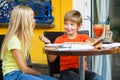 Happy or satisfied boy width girl eating pizza and Royalty Free Stock Photo