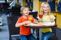 Happy or satisfied boy width girl eating pizza and Royalty Free Stock Photo