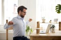 Satisfied businessman sitting at the desk relaxing in office Royalty Free Stock Photo