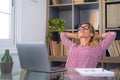 Happy satisfied caucasian woman rest at home office sit with laptop hold hands behind head, dreamy young lady relax finished work Royalty Free Stock Photo