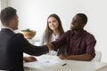 Happy satisfied interracial couple handshaking realtor making re Royalty Free Stock Photo