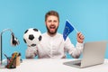 Happy satisfied man holding black and white soccer ball and flag of european union, going to watch football UEFA Champions League Royalty Free Stock Photo