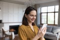 Happy satisfied millennial cellphone user woman browsing internet