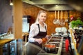 Happy satisfied woman adding condiments for taste in boiling pot with pasta sauce