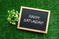 HAPPY SATURDAY! text in white chalk handwriting on a blackboard Royalty Free Stock Photo