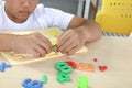 Happy school boy playing with colorful plastic toy and brick block lego on top of table, educational toys with kid hands, Royalty Free Stock Photo