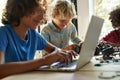 Happy school boy student making robotic car learning at STEM class. Royalty Free Stock Photo