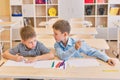 Happy school boys draw in the classroom. Creative little boys Royalty Free Stock Photo