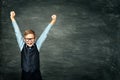 Happy School Child Raised Arms Up, Smart Kid Boy over Blackboard Royalty Free Stock Photo