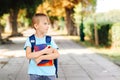 Happy school child is ready to study. Smart schoolboy holding books outdoors. First day to study Royalty Free Stock Photo