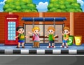 Happy school children at the bus stop Royalty Free Stock Photo