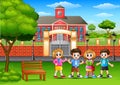 Happy school children standing in outside the front of school building Royalty Free Stock Photo