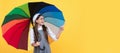 happy school girl in glasses. teen child under colorful parasol pointing finegr. Child with autumn umbrella, rainy Royalty Free Stock Photo