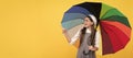 happy school girl in glasses. teen child under colorful parasol pointing finegr. Child with autumn umbrella, rainy Royalty Free Stock Photo