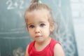 Happy school girl on math classes in kindergarten finding solution and solving problems Royalty Free Stock Photo