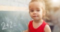 Happy school girl on math classes in kindergarten finding solution and solving problems Royalty Free Stock Photo