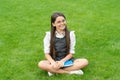 Happy school girl teenager sitting legs crossed on grass. School and education. Back to school Royalty Free Stock Photo