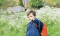 Happy school kid with backpack having fun while walk to school in the morning,Outdoor portrait young boy pointing finger out with Royalty Free Stock Photo
