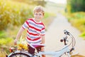 Happy school kid boy having fun with riding of bicycle. Active child making sports with bike in nature. Safety, sports Royalty Free Stock Photo