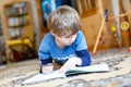 Happy school kid boy at home making homework Royalty Free Stock Photo