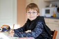 Happy school kid boy at home making homework Royalty Free Stock Photo