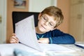 Happy school kid boy at home making homework Royalty Free Stock Photo