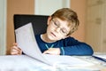 Happy school kid boy at home making homework Royalty Free Stock Photo