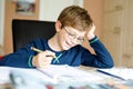 Happy school kid boy at home making homework Royalty Free Stock Photo