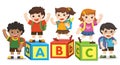 Happy school kids with alphabet blocks. Royalty Free Stock Photo
