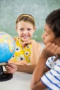 Happy school kids with globe in classroom Royalty Free Stock Photo