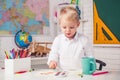 Happy school kids at lesson. Kid gets ready for school. Cute pupil with funny face schooling work. Educational process. Royalty Free Stock Photo